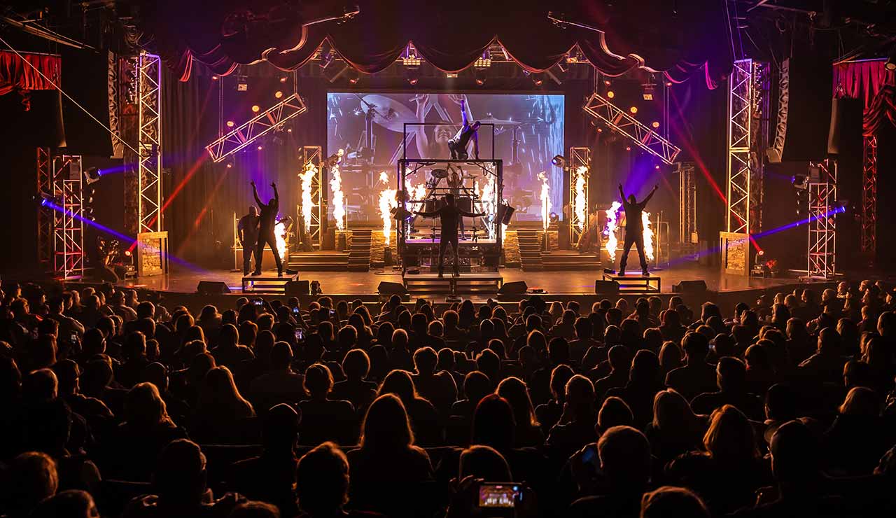 A packed audience watching The Haygoods perform with fire effects