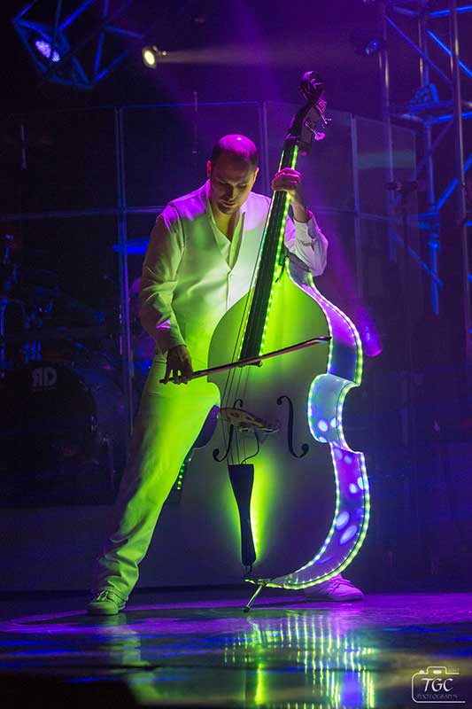 Matthew Haygood playing illuminated upright bass onstage