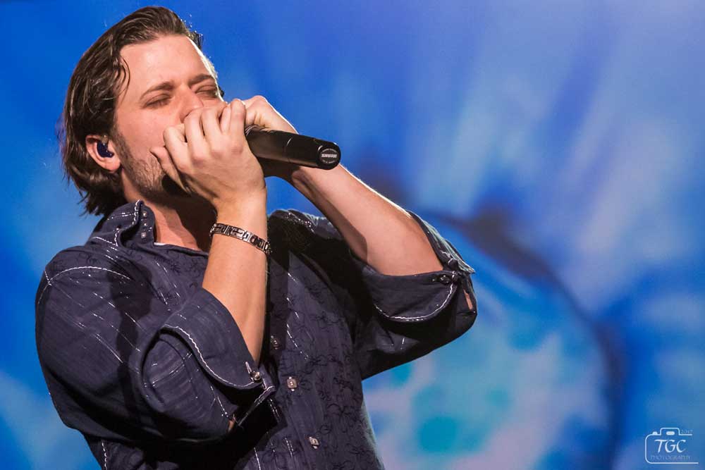 Patrick Haygood playing harmonica onstage